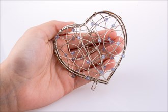 Hand holding Heart cage on a background
