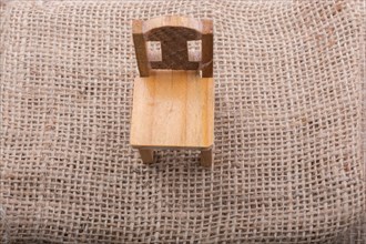 Brown color wooden toy chair on canvas background