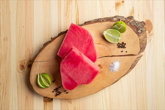 Fresh raw tuna steak on wooden cutting board