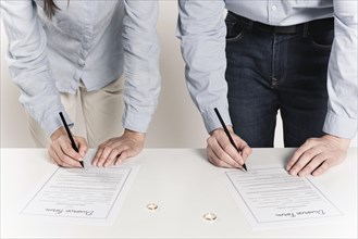 Couple signing divorce forms together