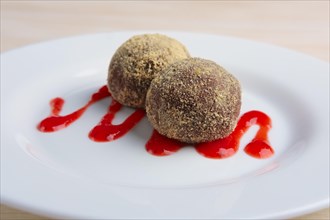 Chocolate truffles with biscuit powder. Rum balls and raspberry jam
