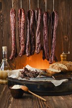Assortment of dried venison sausages on the rope and jerky venison