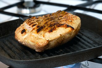 Macro photo with shallow depth of field of pork meat on grill pan