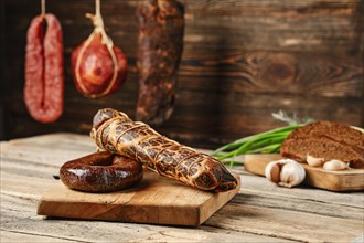 Air dried beef meat and pork sausage on wooden cutting board