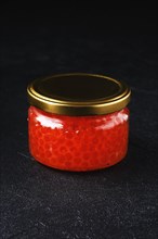Jar with pink salmon red caviar