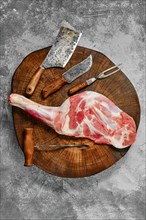 Top view of raw fresh lamb shoulder chump on butcher's cutting log