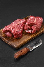 Raw rolled lamb boneless neck meat on cutting board