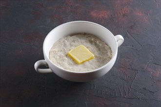 Plate with oatmeal on abstract background