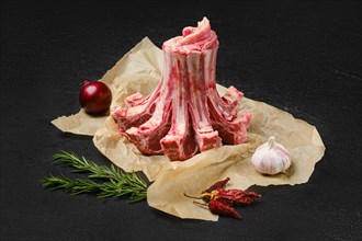 Raw fresh lamb crown roast in wrapping paper