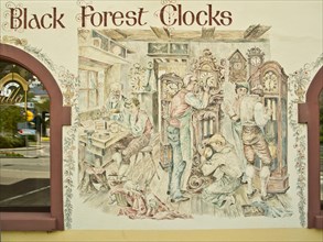 Clockmaker depicted in a facade painting of a Black Forest clock shop in Triberg