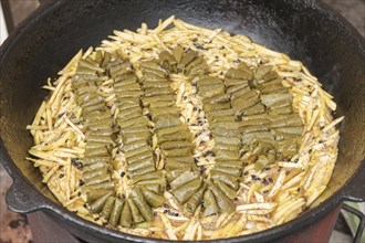Meat and dolma in cauldron. The making of pilaf