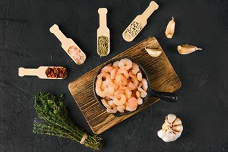 Overhead view of frozen peeled shrimps in frying pan