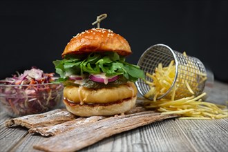 Fishburger on the wooden plates with cheese