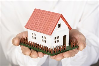 Toy model house held hands close up. Resolution and high quality beautiful photo