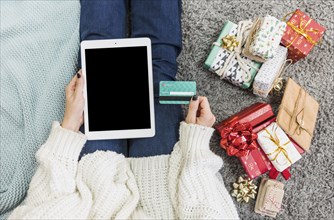Woman with presents credit card with tablet. Resolution and high quality beautiful photo