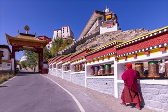 A monk walking towards Thikse Monastery