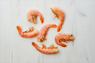 Top view of unpeeled shrimp on wooden table