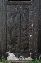Burned wooden door with vertical texture