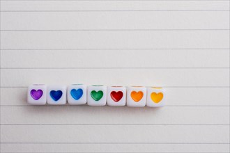 Colorful cubes with a heart placed on paper