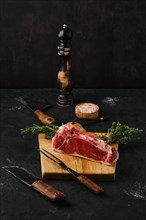 Raw strip steak boneless on dark background