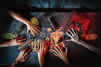 Top view of hands in quest game. Solving a puzzle during riddle. Escape the room game concept