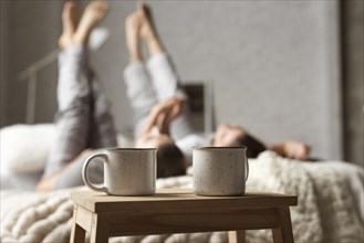 Coffee cups table with couple bed