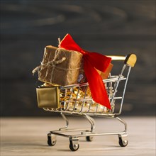 Small grocery cart with gift box with red band. Resolution and high quality beautiful photo
