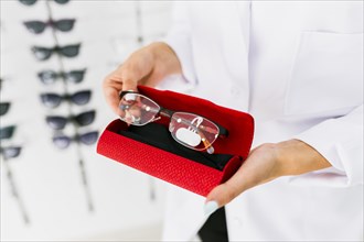 Woman holding red case eyeglasses. Resolution and high quality beautiful photo