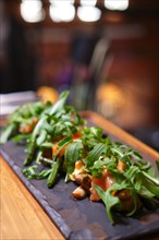 Smoked salmon with mushroom and bean decorated with ruccola. Photo taken with shallow depth of field