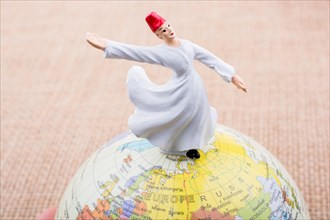 Swirling dervish on a globe on a textured background