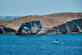 Yacht boat in blue waters of Aegean sea near Milos island