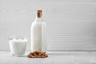 Bottle and glass with almond milk