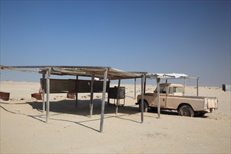 Car park in the desert with old pick-up trucks