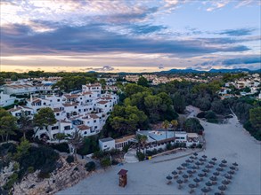 Sunset over Cala Anguila-Cala Mendia from a drone