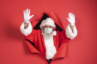 Man santa costume with medical mask coming out paper