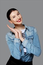 Pretty fashion model in jeans shirt with tan makeup and red mat lips
