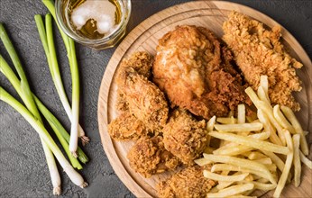 Top view fried chicken with fries cutting board green onions. Resolution and high quality beautiful photo