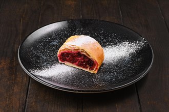 Piece of classic cherry strudel on a plate
