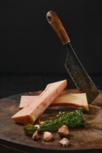 Raw beef bone marrow chopped on half on wooden stub
