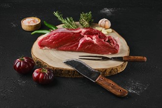 Raw top sirloin beef steak on wooden cutting board