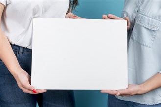 Girls holding blank board