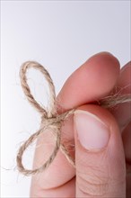 Thread knot in hand on a light color background