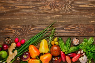 Top view of wooden background with different types of vegetables