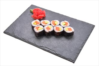 Rolls with salmon and avocado on slate plate isolated on white