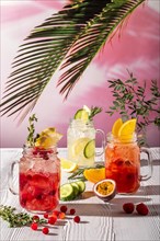 Different lemonades with different fruits and syrups on wooden table under morning sun