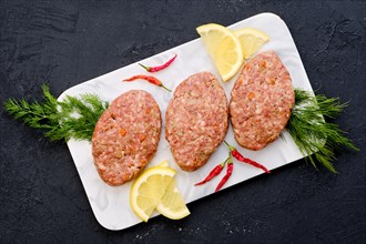 Uncooked cutlet with minced beef meat and cabbage ready for cooking