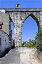 18th century historical Aqueduct of the Free Waters or Aguas Livres Aqueduct crossing a popular district