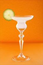 Gin tonic cocktail on orange background