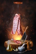 Poster with raw lamb ribs on hook over wooden stumb