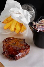 Grilled ribs served with fried potato and red cabbage